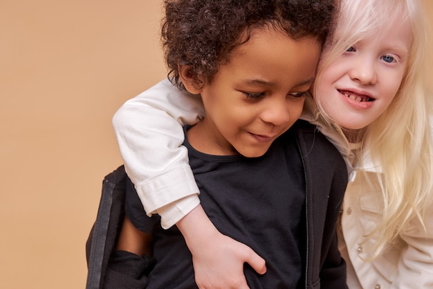 Cute adorable diverse children smiling together isolated