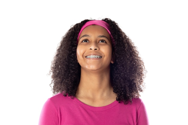 Cute African teenager wearing a pink headband isolated on a white background