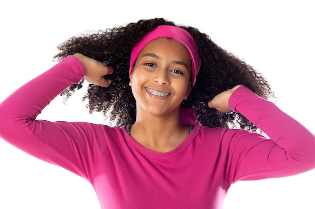 Cute African teenager wearing a pink headband isolated on a white background