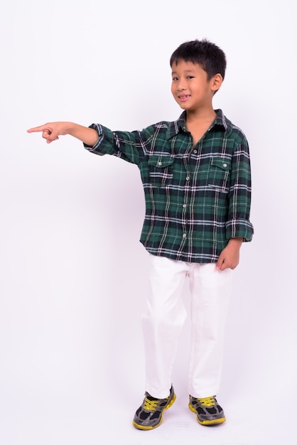  cute Asian boy wearing green checkered shirt against white wall