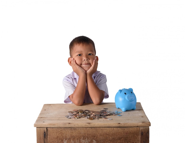 Cute asian country boy have thinking with piggy bank and coins isolated on white background