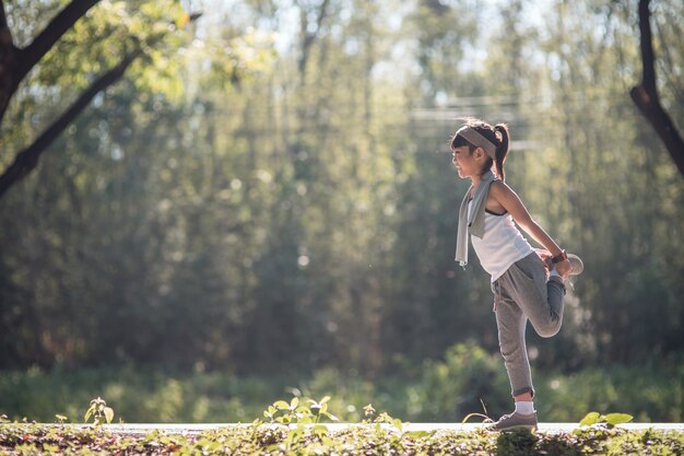 Cute asian girl exercise in gardent background