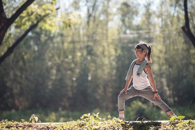 Cute asian girl exercise in gardent background