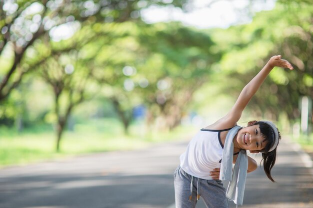 写真 庭の背景で可愛いアジア人女の子の運動