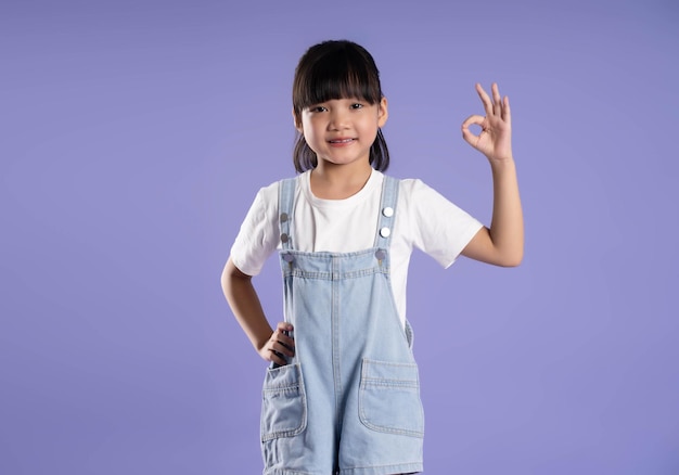 cute asian girl posing on purple background