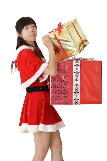 크리스마스 선물을 찾고 산타 옷에 귀여운 아시아 소녀.