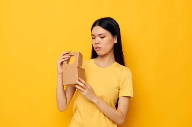 Cute asian girl with a small box in her hands monochrome shot