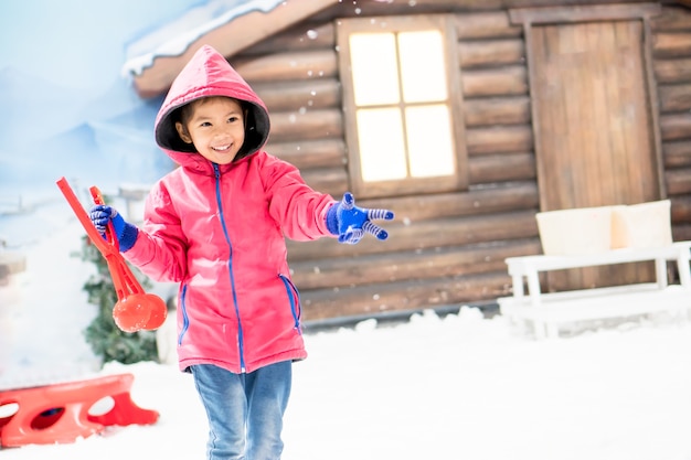 Cute asian little child girl wearing pink jacket playing 