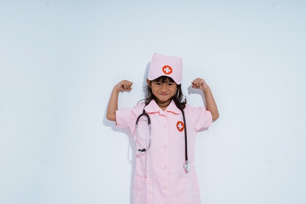 Cute asian little girl wearing a doctor uniform