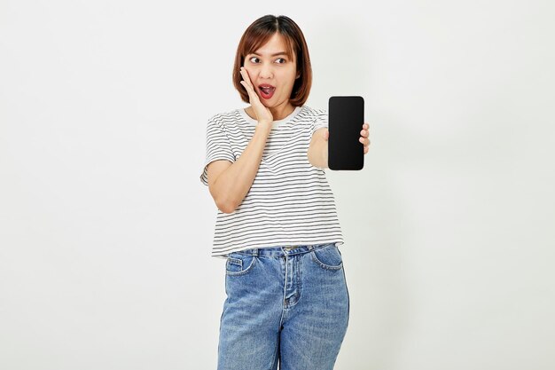 Cute asian short brunette hair woman promotes smartphone app woman blogger showing personal social media page hold phone look camera happily smiling on white background