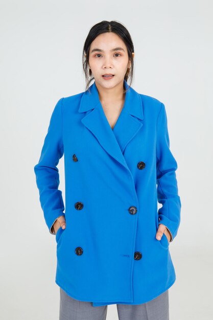 Cute Asian woman professional happy and friendly smile with confident on smart uniform of blue jacket. Healthy and cheerful lady standing and convinced of charming costume and attractive outfit style.