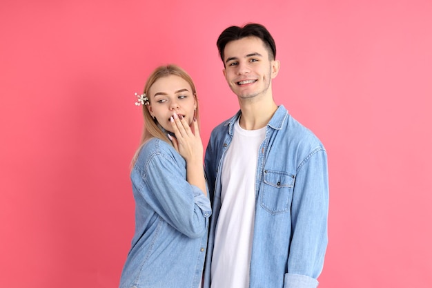 Cute and attractive couple on pink background