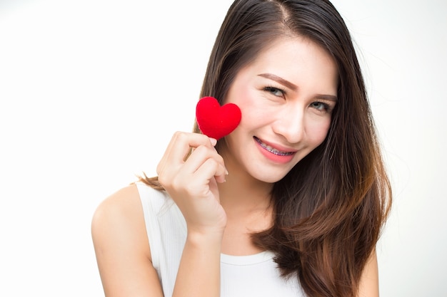 Photo cute attractive young woman with red heart. valentine's day art portrait.