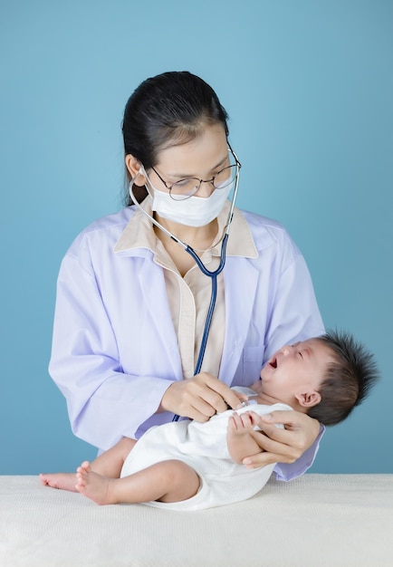 Cute baby being examined by female doctor