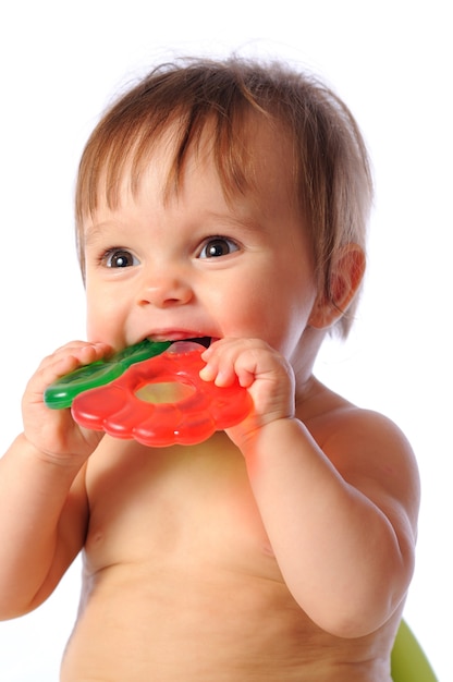 Cute baby bitting into toy