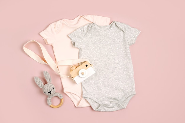 Cute baby bodysuits with toys. Set of kids clothes and accessories. Fashion newborn. Flat lay, top view