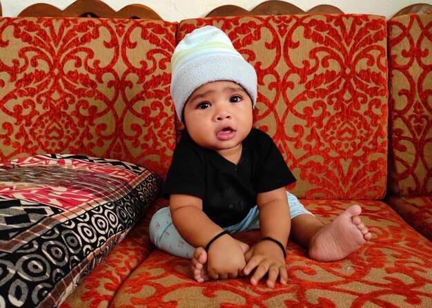 Cute baby boy on bed at home