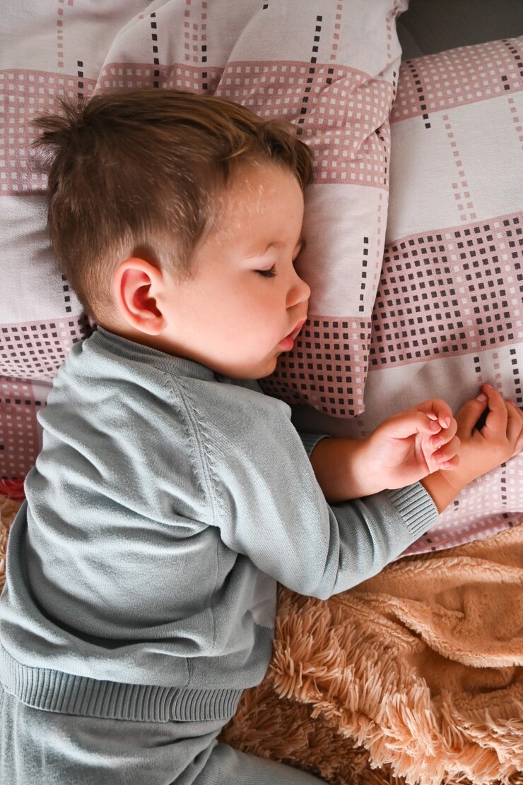 Cute baby boy is sleeping in daytime. Childhood, crib.