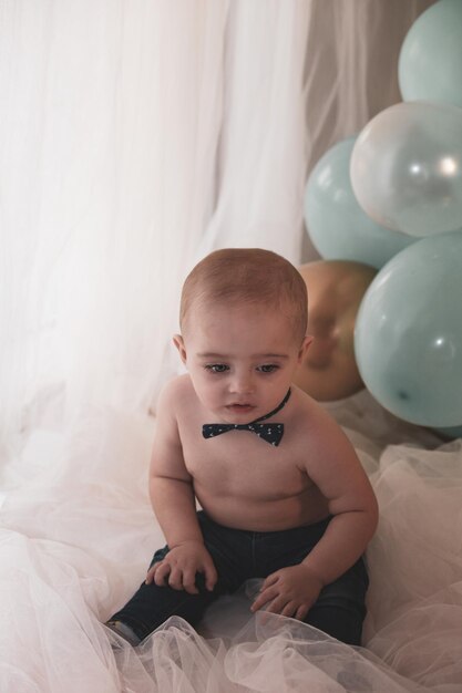 Cute baby boy lying on bed at home