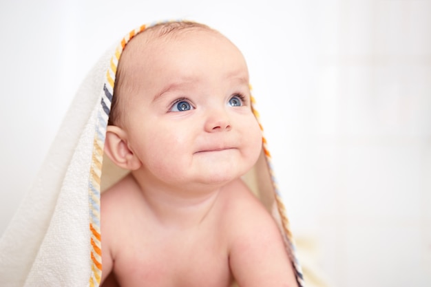 Cute baby boy sitting after bathing