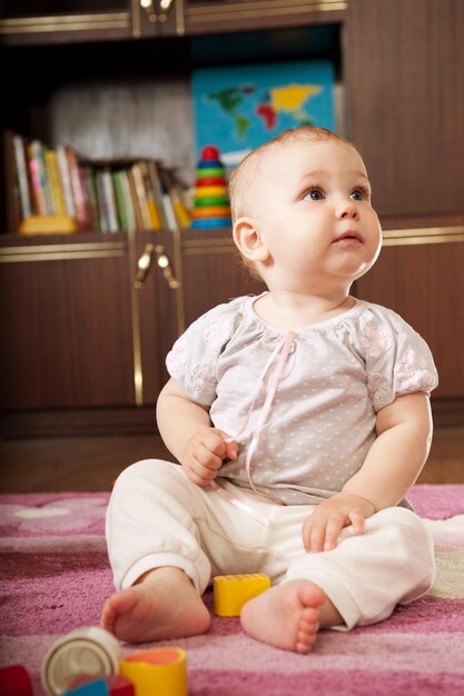 Cute baby boy sitting at home