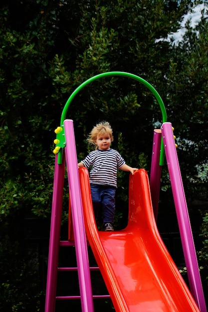 Cute baby boy on slide