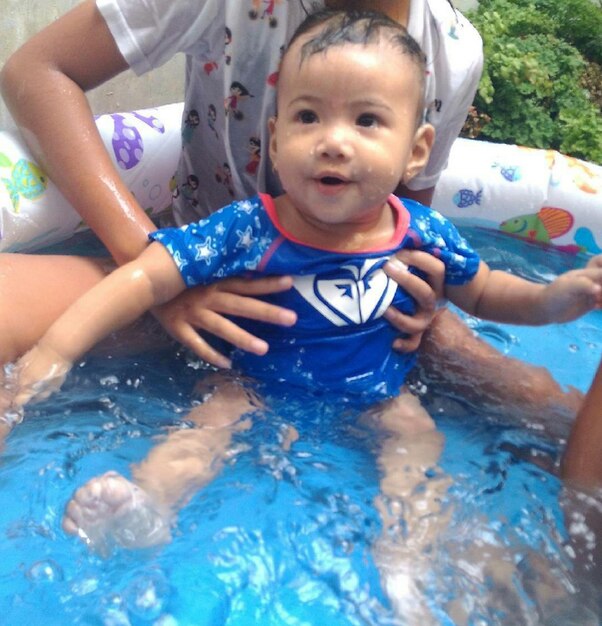 Cute baby boy in swimming pool