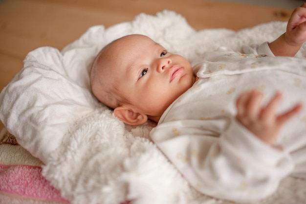 Cute baby boy in a white light bedroom Newborn baby is cute In bedding for children born images