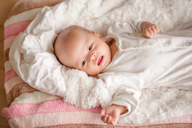 Cute baby boy in a white light bedroom Newborn baby is cute. 