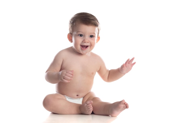 Cute baby in diaper looking at the camera isolated on a white background