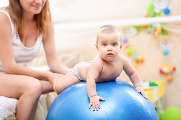 Cute baby engaged in childrens gymnastics