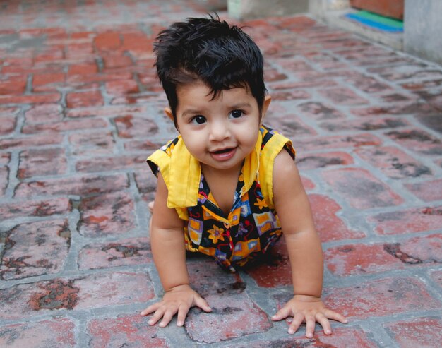 Cute baby girl on footpath