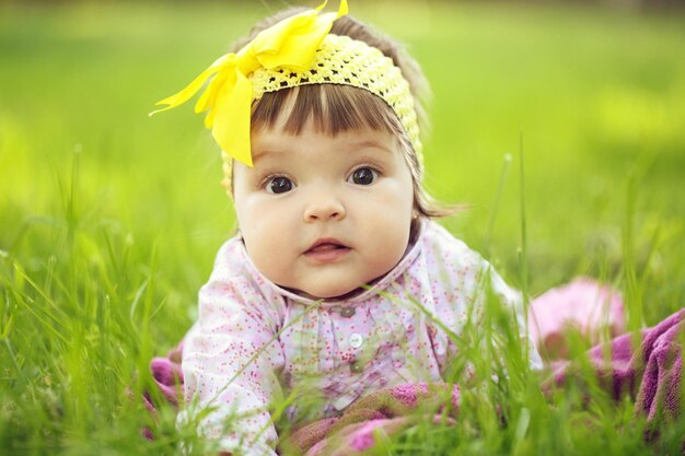 Cute baby girl on green grass