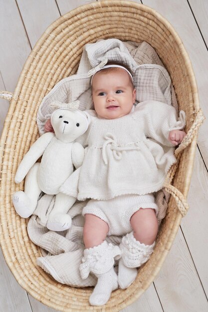 Photo cute baby girl in knitted clothes mother's day international day of happiness