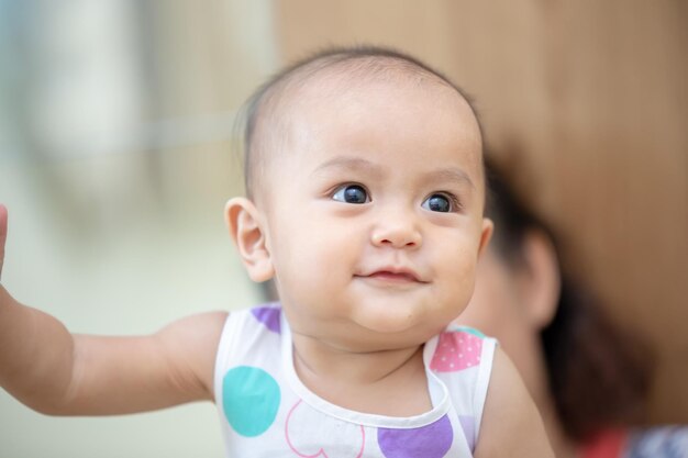 Cute baby girl looking away at home