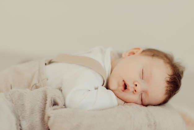 cute baby girl sleeping on bed at home