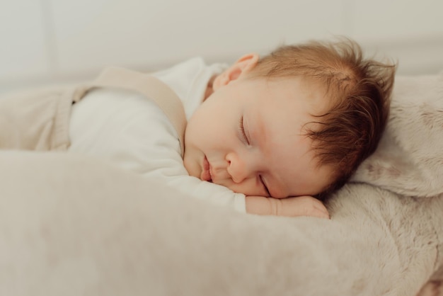 Cute baby girl sleeping on bed at home