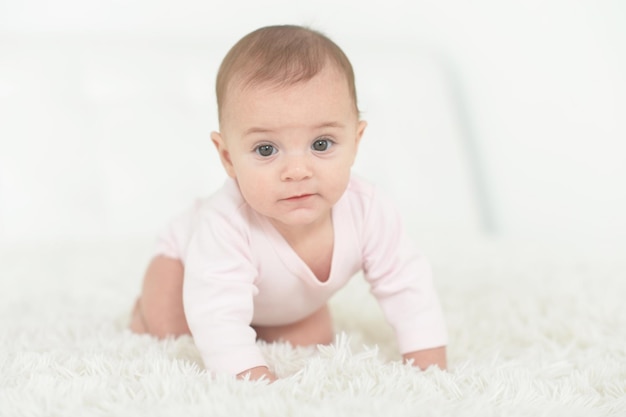 Cute baby girl on white blanket