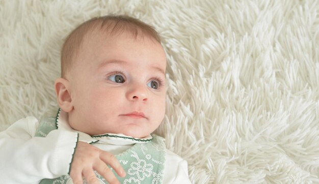 Cute baby girl on white blanket