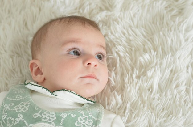 Cute baby girl on white blanket