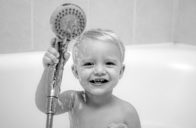 Photo cute baby is washing her hair in bath concept for healthcare and daily routine baby with a towel after taking a bath kid bath