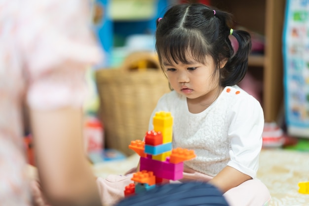 Cute baby playing toy at the living room