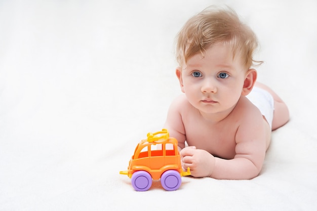 Cute baby playing with a toy car