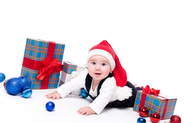 Cute baby in a red New Year's cap with a smile on his face 