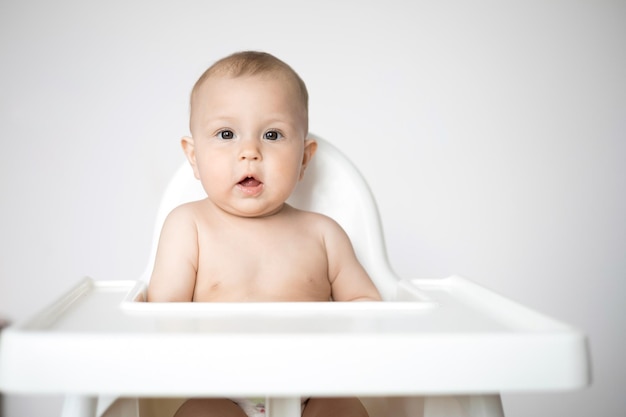 Cute Baby sits in a highchair Space for text Lifestyle