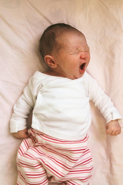 Cute baby sleeping on bed