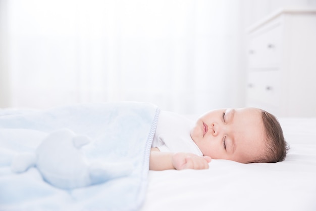 Cute baby sleeping in bed