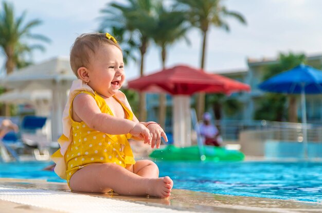 Cute baby splashing in swimming pool