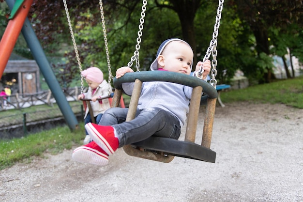 Cute Baby Twins Having Fun on a Swing