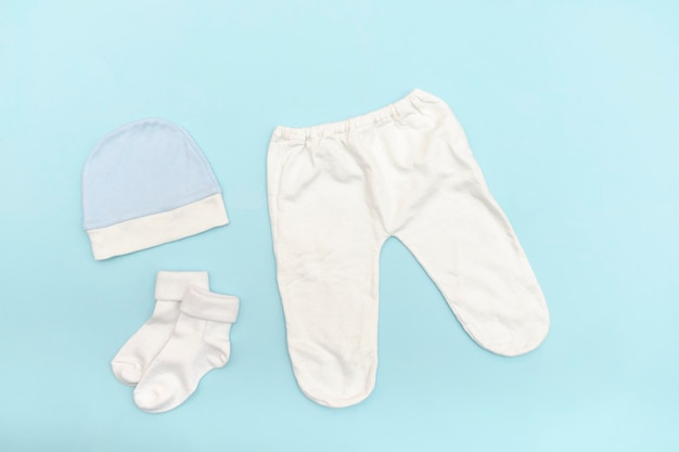 Cute baby white trousersbodysuithat socks Set of kidschildrens clothes and accessories in blue color newborninfant fashion outfit Flat lay top view